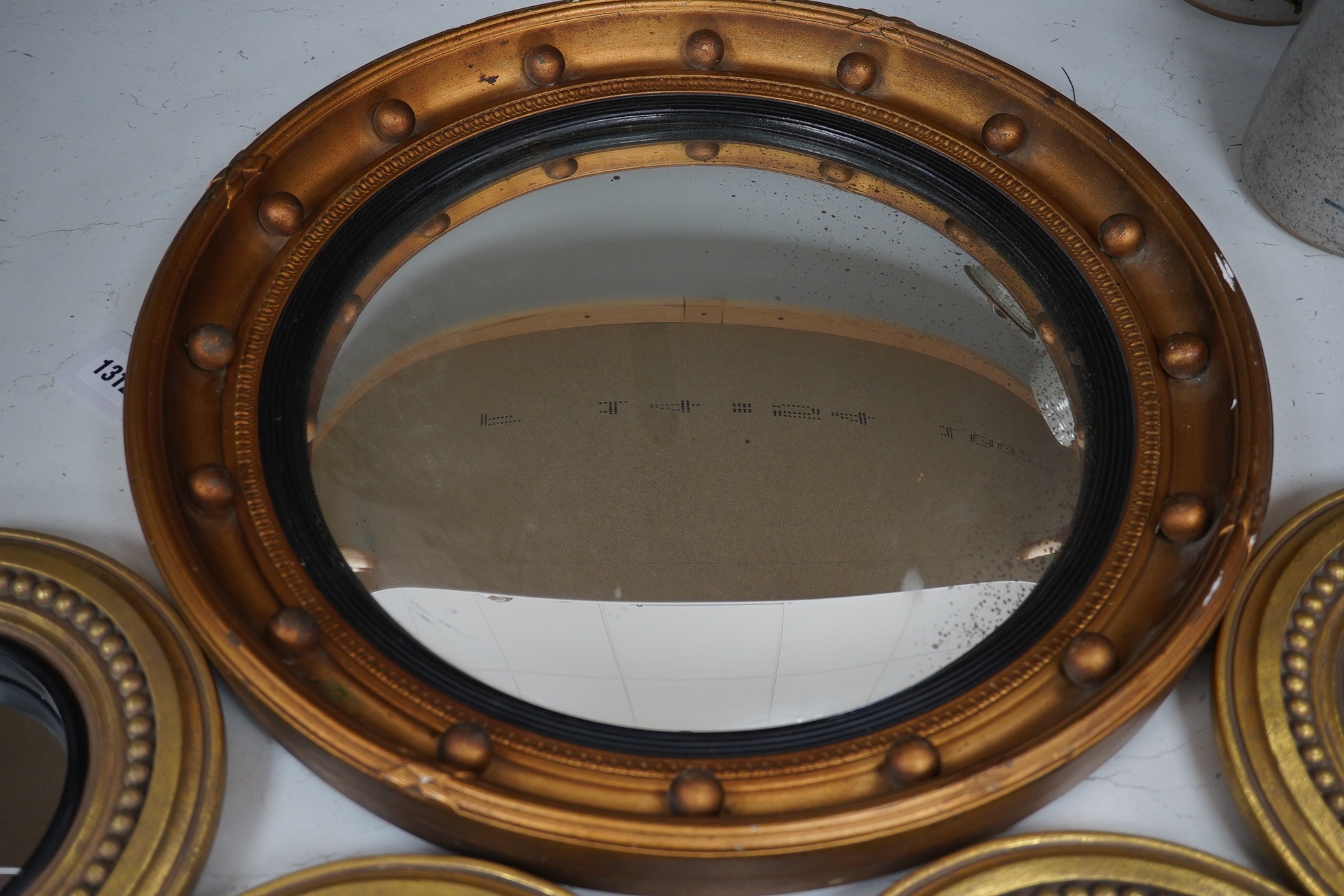 A convex gilt painted wall mirror and four small similar mirrors, convex mirror 46cm diameter (5). Condition - convex mirror, gilt scratched in places, others good